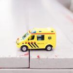 Rescue Organization - yellow car toy on white surface