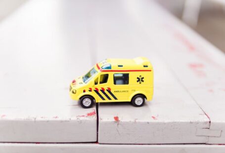 Rescue Organization - yellow car toy on white surface