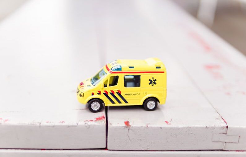 Rescue Organization - yellow car toy on white surface