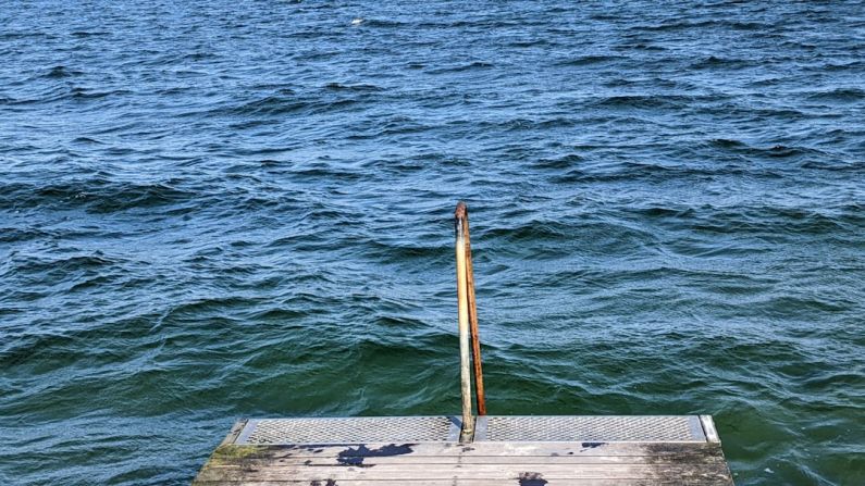 Dock Diving - a wooden dock sitting on top of a body of water
